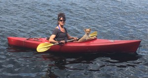 A girl and her dog kayaking at mainstay